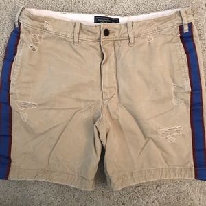 Men’s tan shorts with side stripes